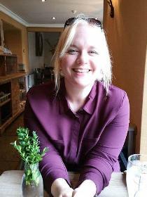 Headshot of author CJ Skuse - a white woman with blonde hair. She is smiling at the camera.